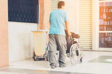 Disabled women in wheelchair with her husband in the hospital.の写真素材