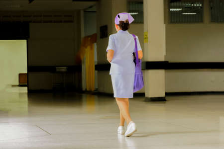 Nurse shoulder bag purple is walking to the laboratory in the hospitalの写真素材