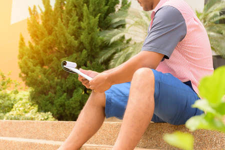 Man sitting on stairs and reading your note paper.