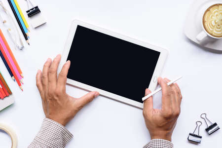 Hands with  tablet computer with coffee cup and etc on isolated.Top view.