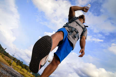 Man backpack drinking water or African man backpack.の写真素材