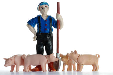 farmer with plastic toy pigsの写真素材