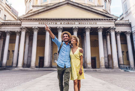Couple of tourists walking in the city of Milan, Italy - People visiting Romeの写真素材