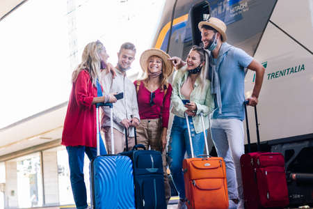 Multiracial group of people walking at train station. Travel, holiday and vacation new normal concept.の写真素材