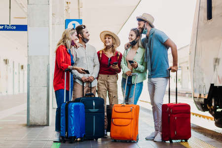 Multiracial group of people walking at train station. Travel, holiday and vacation new normal concept.の写真素材