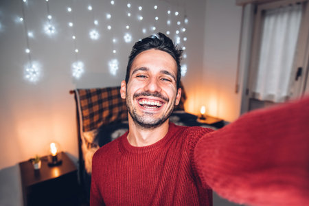 Handsome man taking selfie at home - Smiling guy looking at cameraの写真素材