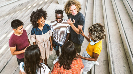 Group of multiracial young people having fun together on city street