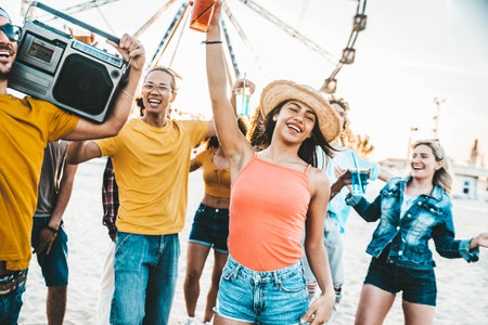 Multiracial group of friends having fun dancing on the beachの写真素材