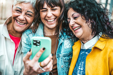 Group of senior female using smart mobile phone device outside