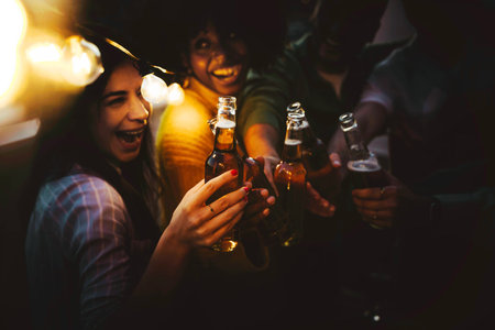 Happy friends enjoying night party on rooftop terraceの写真素材