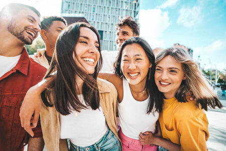 Multiethnic friends having fun walking on city street