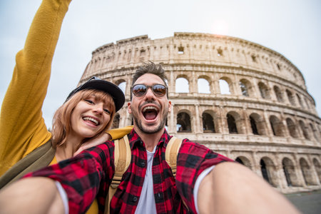 Happy couple visiting Colosseum in Rome, Italy - Young Friends takes selfie at Coliseumの写真素材