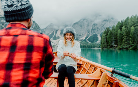 Romantic couple on a boat visiting an alpine lake at Braies Italyの写真素材