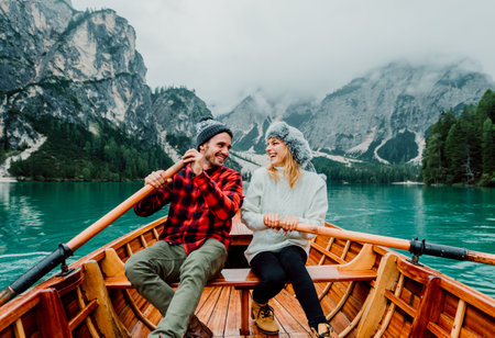 Romantic couple on a boat visiting an alpine lake at Braies Italyの写真素材