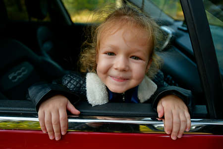 Little girl on a walk in the autumn city park.