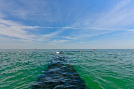 Ukraine, Odessa 07/26/2020. Dolphin is wide enough, clean, well-groomed, mostly sandy beach, bordered by green slopes. The entrance to the beach is free, but services are paid. There is a playground,のeditorial素材