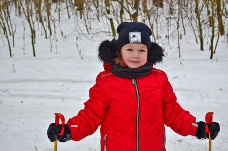 Little girl child goes skiing in winter.