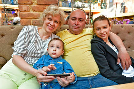 Two families are having dinner at a restaurant.