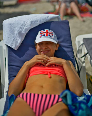 Friends with families with children are resting on the seashore.の写真素材