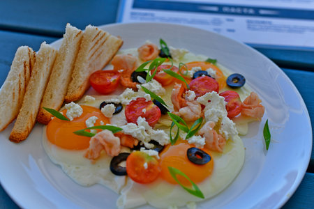 Fried eggs with toast, restaurant serving.の写真素材