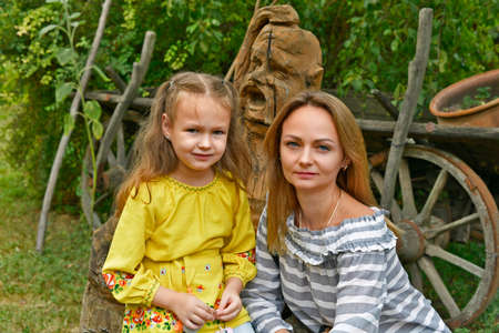 A beautiful adult woman and her little daughter at the Sorochinskaya fair.