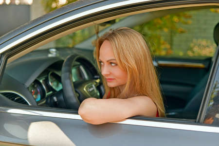 Beautiful young woman driving a car.