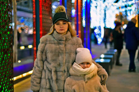 Mom and daughter walk around the city, Dnepropetrovsk, Ukraine, decorated with New Year's decor.の写真素材