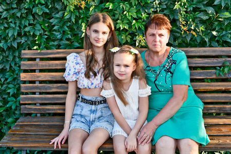 On the anniversary of an adult woman turning 65, the whole extended family celebrates.