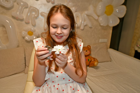 The family celebrates the child's birthday with friends. They have fun, entertain themselves, play games, eat a birthday cake.の写真素材