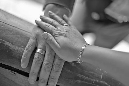 A mature couple, husband and wife, are celebrating their wedding anniversary with their children. A country recreation center on the shore of a lake, in September.の写真素材