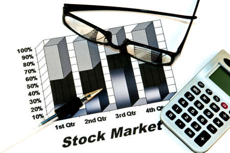 black stock market chart with glasses,pen and calculatorの写真素材