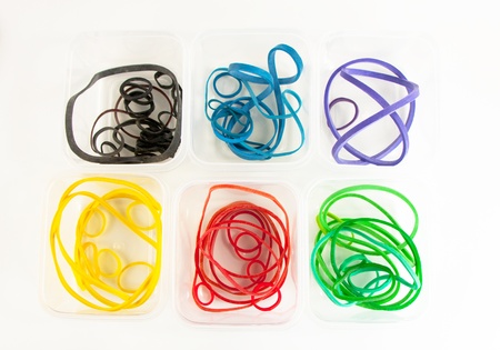 Color rubberbands piled in containers