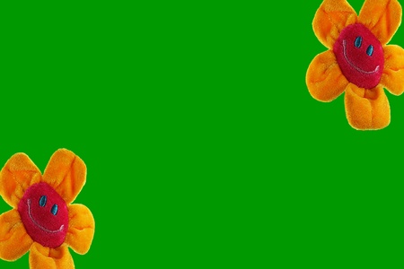 Two yellow and red smiling sunflowers,each in a corner, with a green background. Middle left open for text.の写真素材