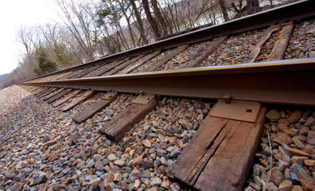 Railroad tracks with stone by the river