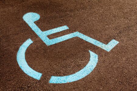 Handicap icon painted blue in a parking lot の写真素材