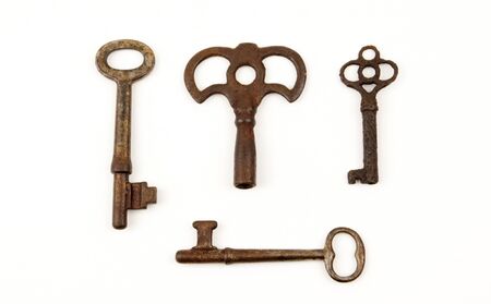 Rare antique keys together isolated on whiteの写真素材