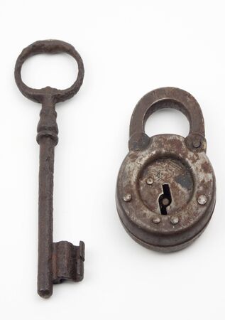 Antique lock and key together isolated on whiteの写真素材