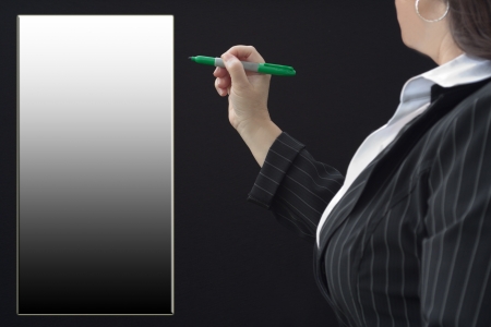Businesswoman with pen in hand getting ready to draw on gradient empty spaceの写真素材