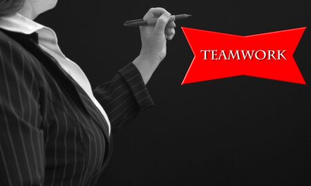 Businesswowan with teamwork red text as backgroundの写真素材