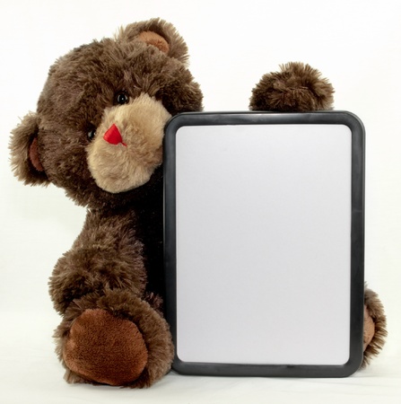 A brown bear holding a blank dry erase boardの写真素材