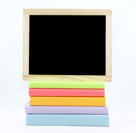 Chalkboard on top of colored booksの写真素材