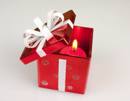 Red candle Christmas box isolated on whiteの写真素材