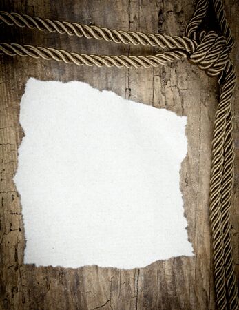 Brown rope and paper on wooden backgroundの写真素材