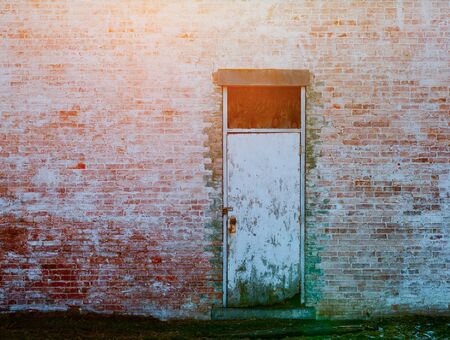 An old concrete building with a wooden doorの写真素材