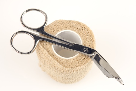 Professional scissors and an ace bandage isolated on whiteの写真素材