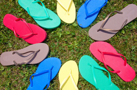 Flip-flops in a circle in the grassの写真素材