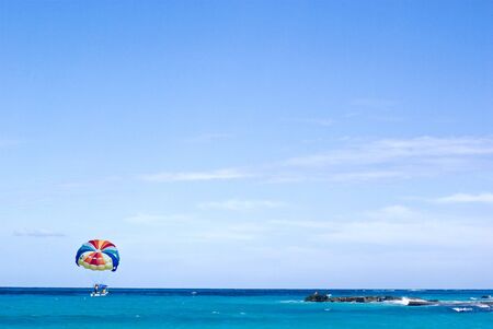 boat and parasailing in cancun beachの写真素材