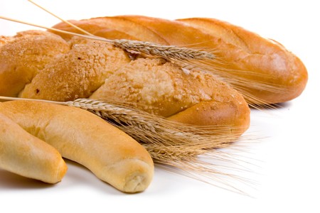 Fresh bread with ears of wheat  on a white backgroundの写真素材