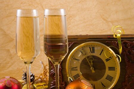 Decoration with a clock, christmas balls and champagne glasses 