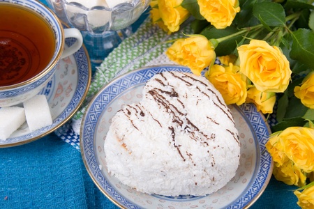 Romantic tea.  Tea,  cake  and  roses  on a blue background. Valentine's Day